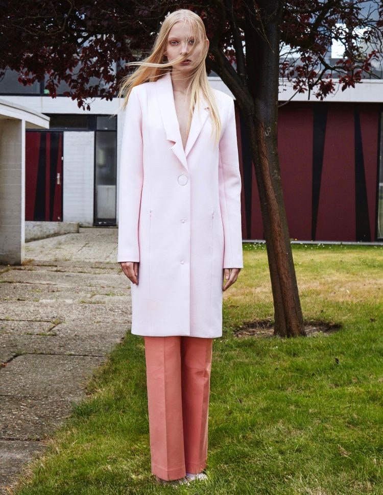 Nikita Lauffer in a pink coat on the grass