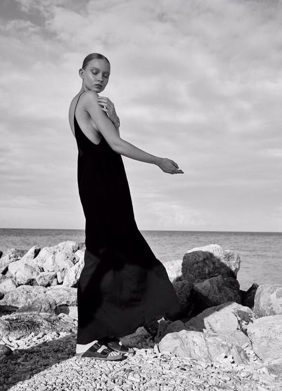 Black and white portrait in a black dress on rocks