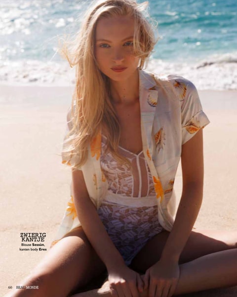 Magazine page: Nikita Lauffer on the beach in a sheer shirt
